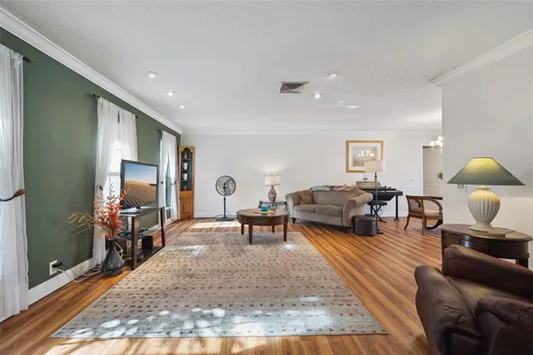 a living room with furniture and wooden floor