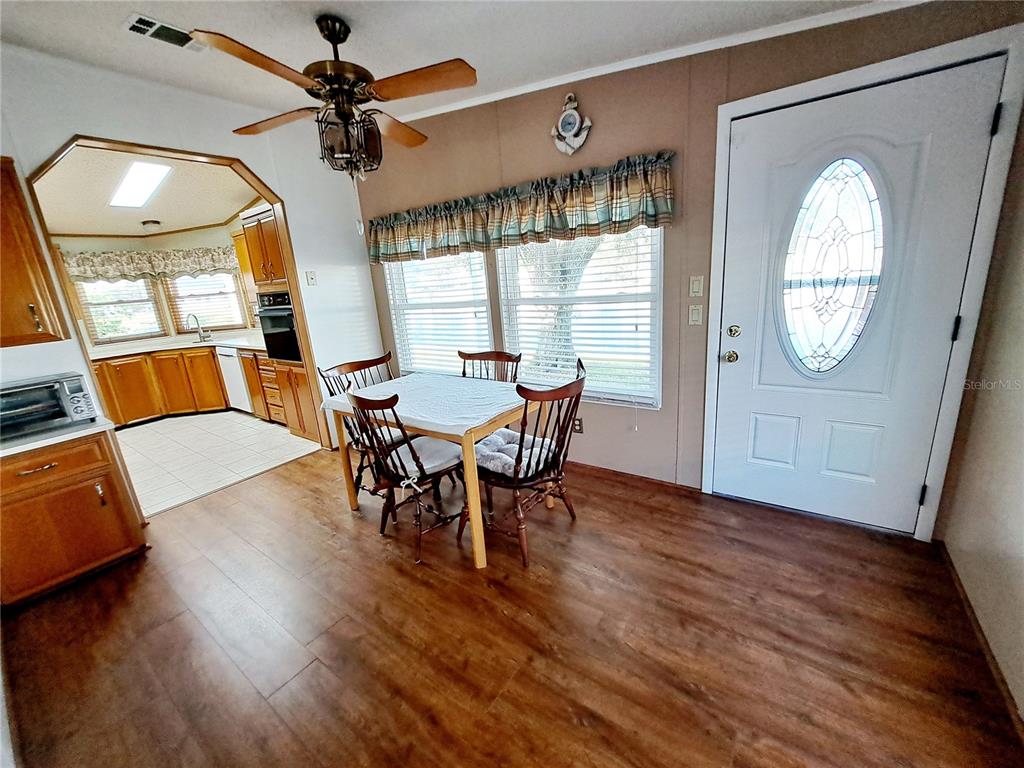 116 Maple Leaf Drive Palm Harbor, FL 34684 - Photo 11 of 38 a view of a dining room with furniture window and wooden floor