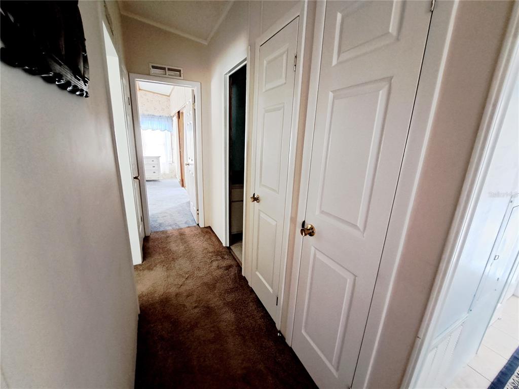 116 Maple Leaf Drive Palm Harbor, FL 34684 - Photo 17 of 38 a view of a hallway with wooden floor and entryway