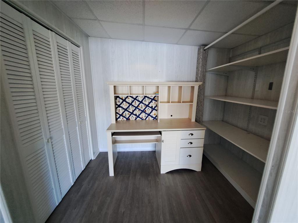 116 Maple Leaf Drive Palm Harbor, FL 34684 - Photo 23 of 38 a room with a white cabinets and wooden floor