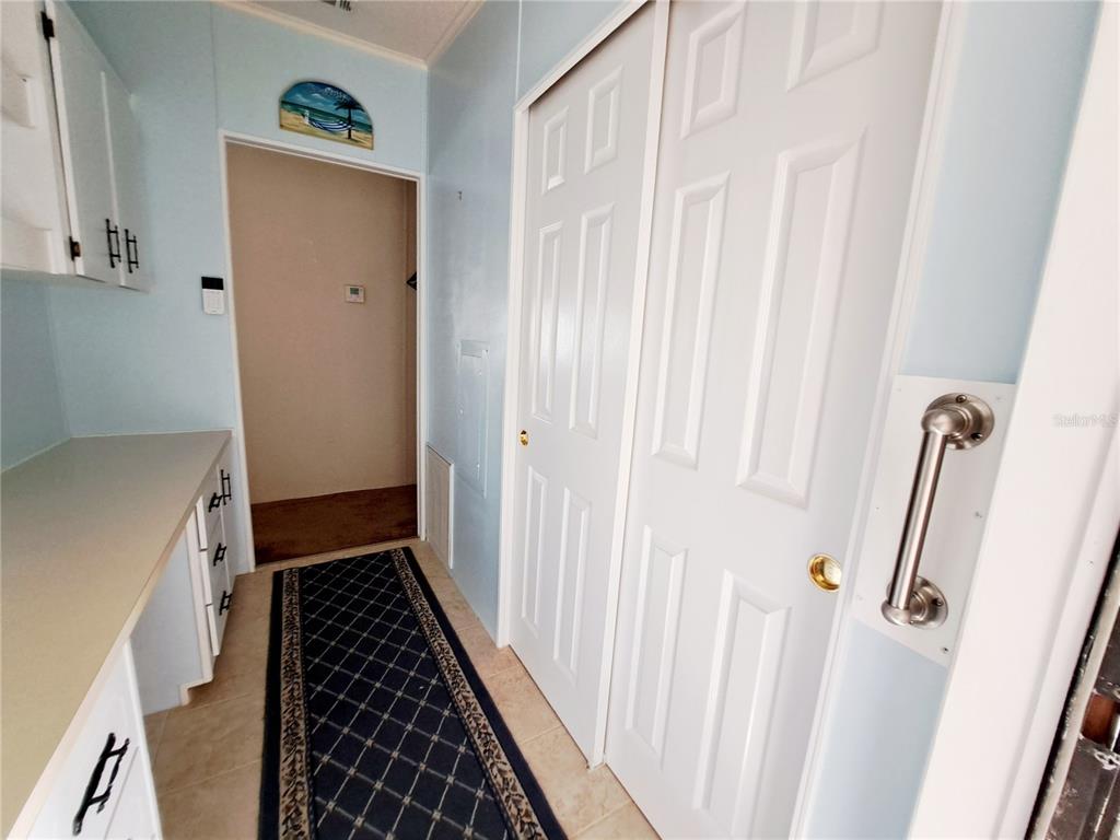 116 Maple Leaf Drive Palm Harbor, FL 34684 - Photo 25 of 38 a walk in closet with wooden floor
