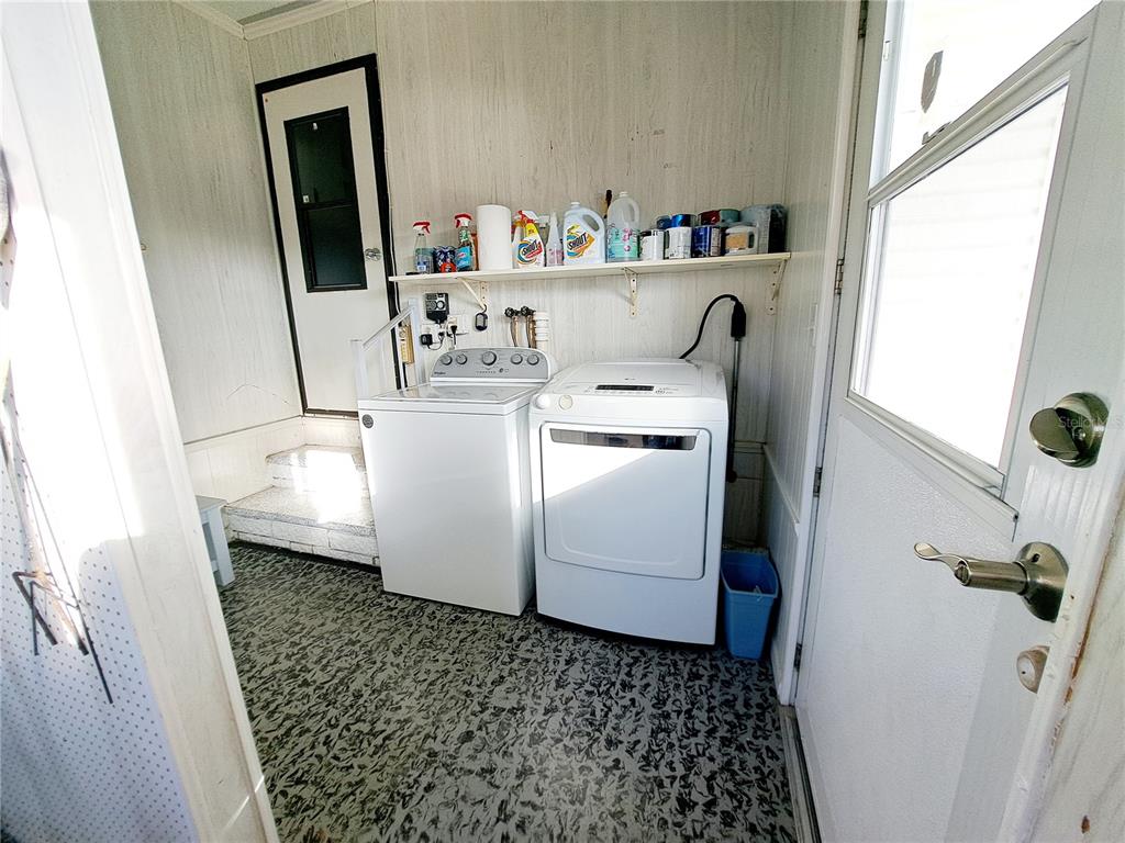 116 Maple Leaf Drive Palm Harbor, FL 34684 - Photo 27 of 38 a utility room with dryer and washer