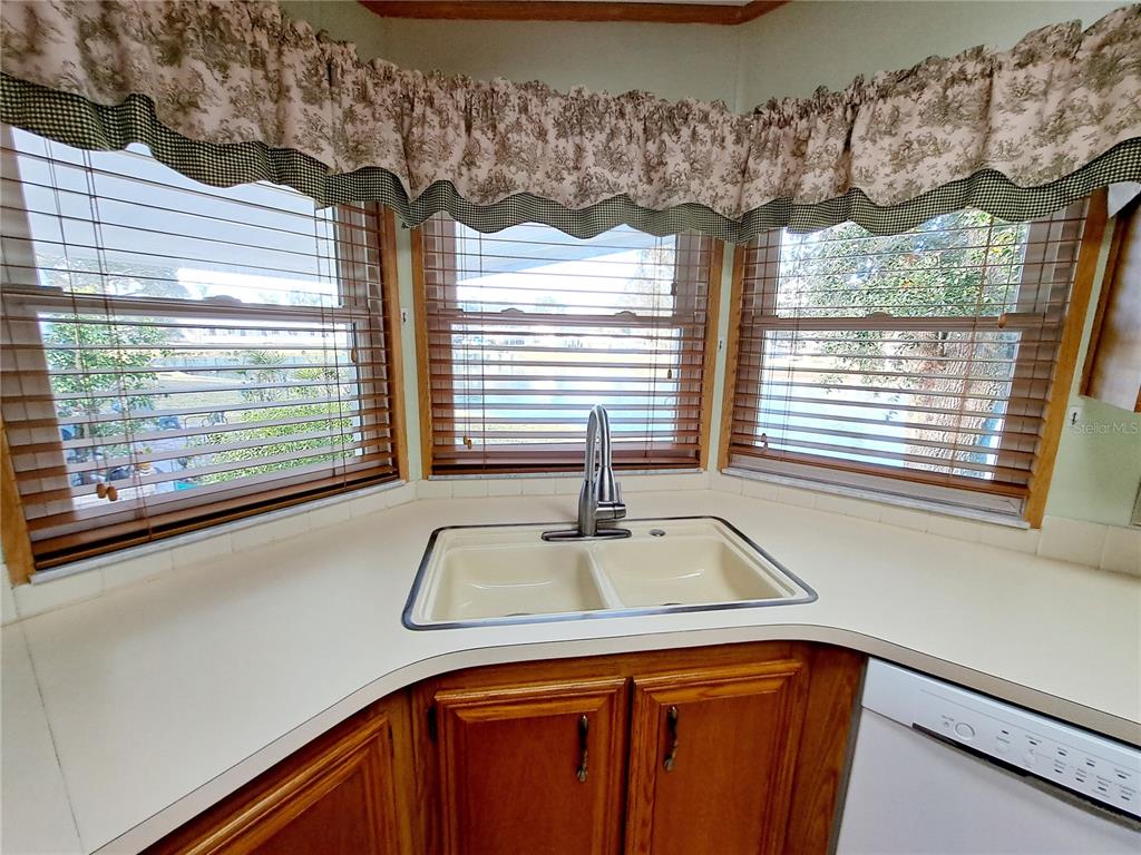 116 Maple Leaf Drive Palm Harbor, FL 34684 - Photo 10 of 38 a kitchen with a sink and large window