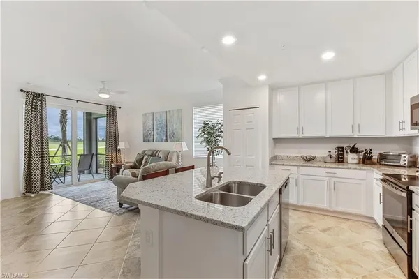 a kitchen with a sink stove and cabinets