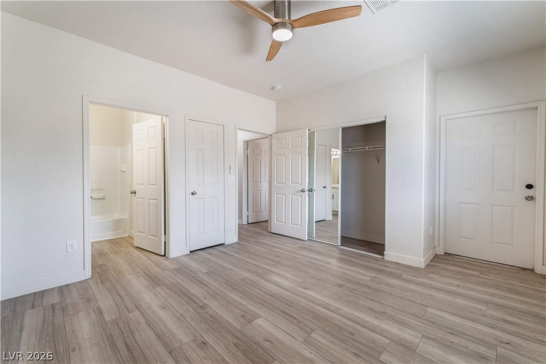 4730 East Craig Road, Unit 1058 Las Vegas, NV 89115 - Photo 17 of 30 A well-proportioned bedroom showcases ample closet space and light wood-style flooring.