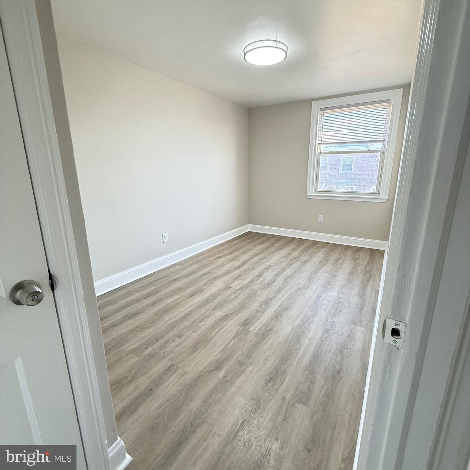 7219 Large Street Philadelphia, PA 19149 - Photo 16 of 20 a view of an empty room with wooden floor and a window