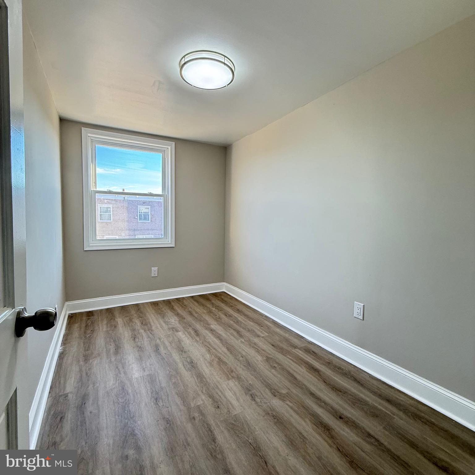 7219 Large Street Philadelphia, PA 19149 - Photo 17 of 20 a view of an empty room with wooden floor and a window
