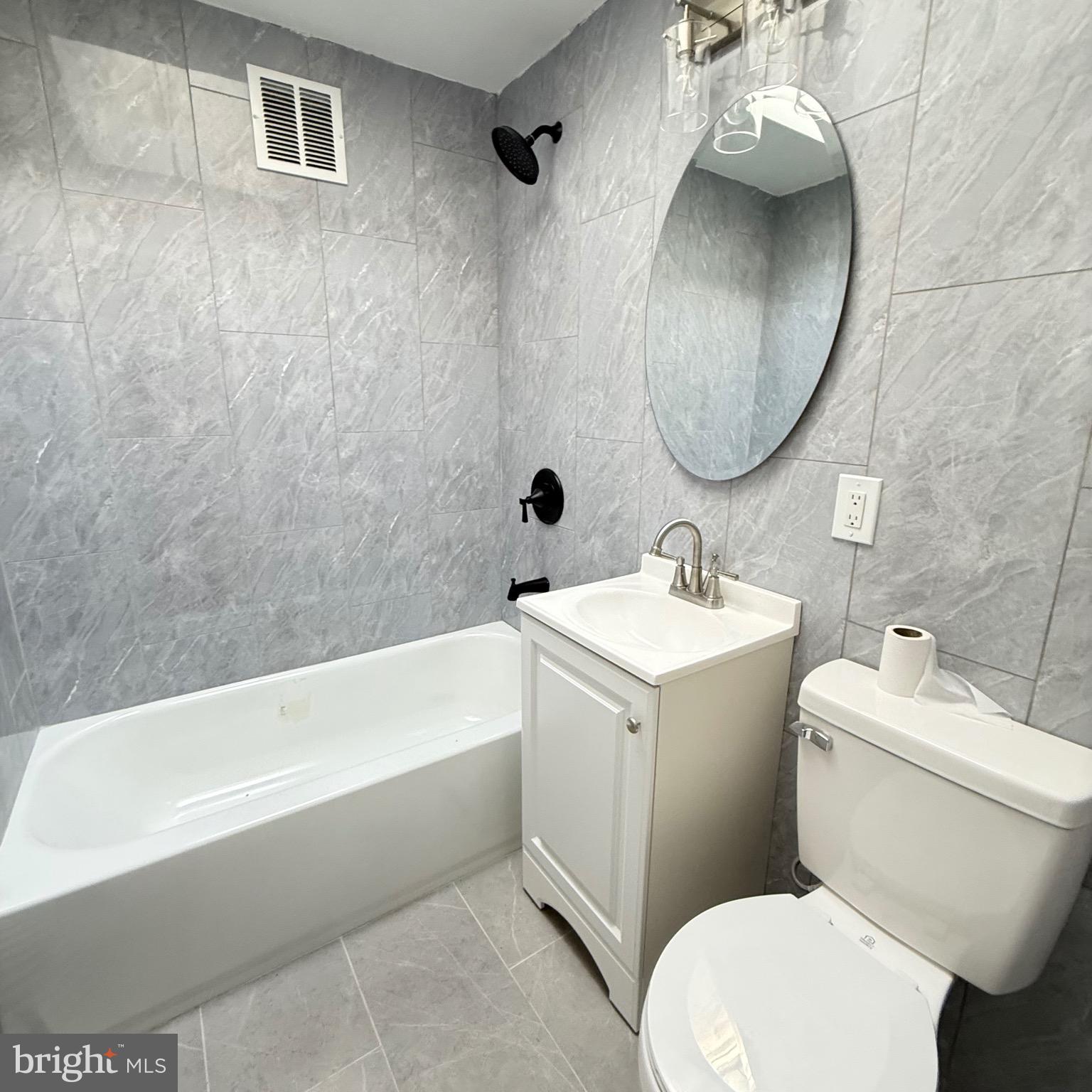7219 Large Street Philadelphia, PA 19149 - Photo 19 of 20 a bathroom with a sink a mirror and a toilet
