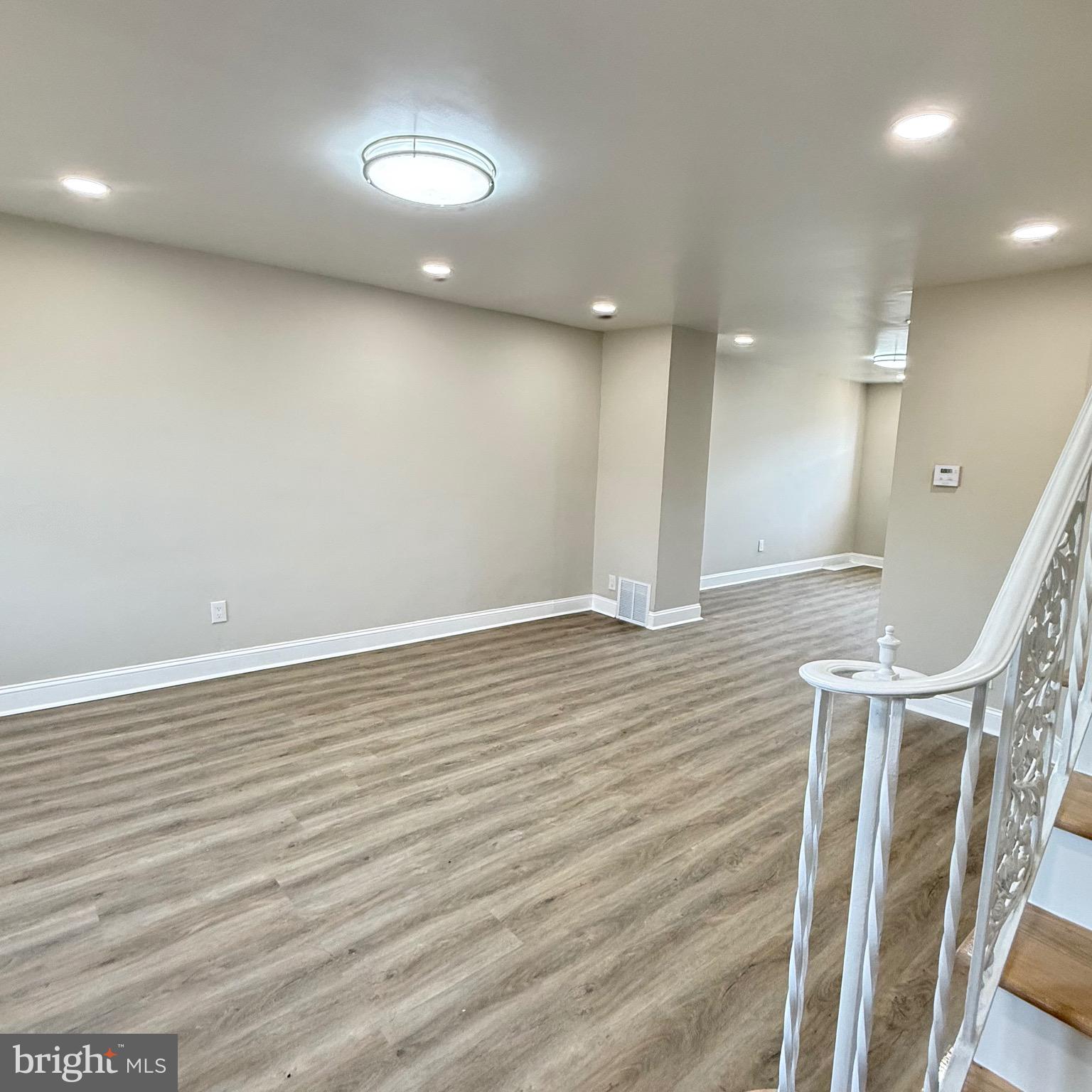 7219 Large Street Philadelphia, PA 19149 - Photo 6 of 20 an empty room with wooden floor and entrance