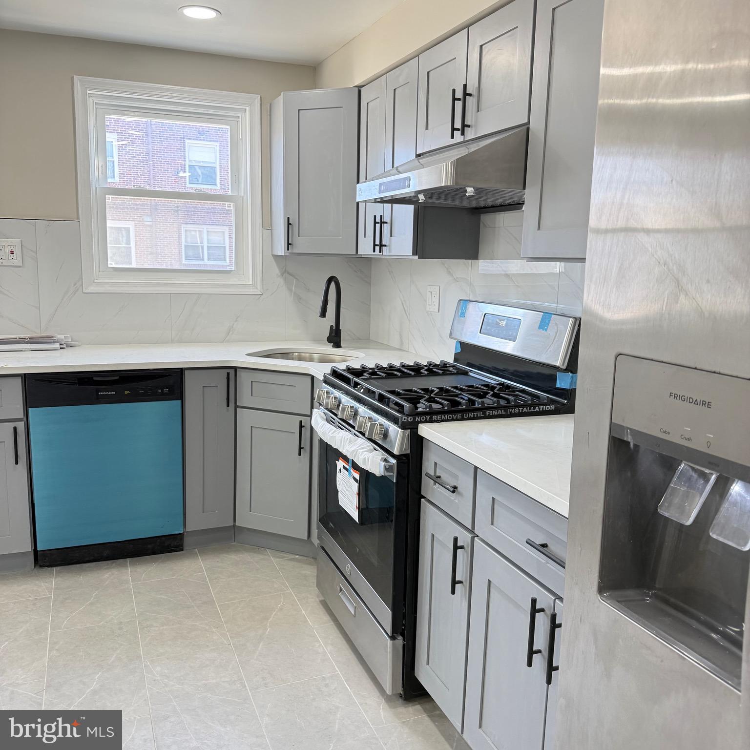 7219 Large Street Philadelphia, PA 19149 - Photo 9 of 20 a kitchen with cabinets appliances and a window