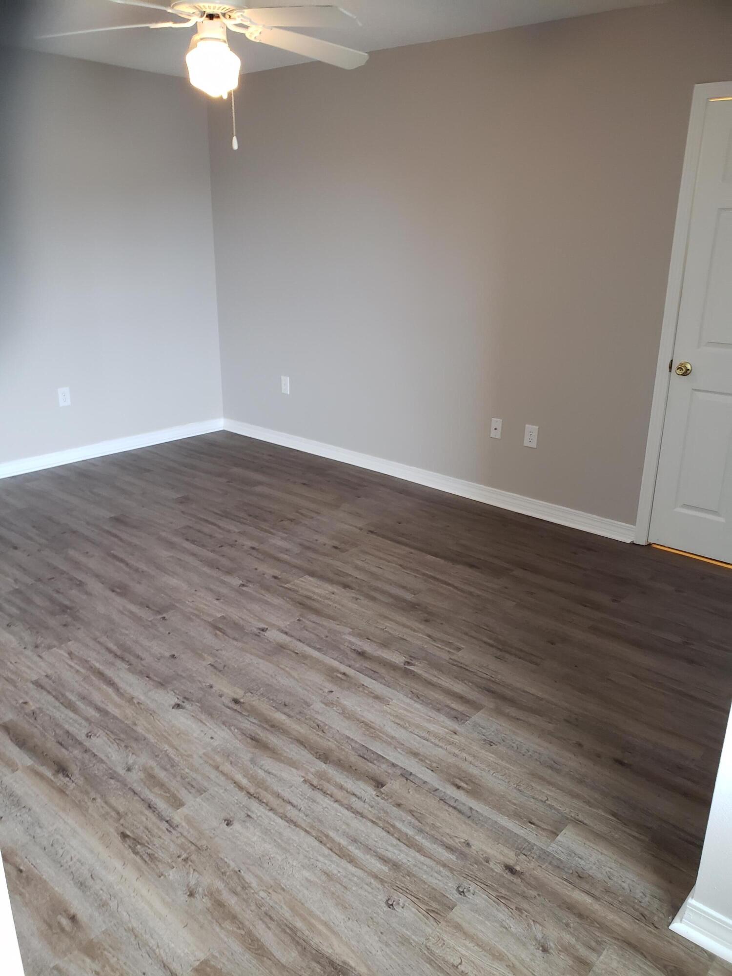 2127 Tom Street Navarre, FL 32566 - Photo 4 of 14 a view of an empty room with wooden floor