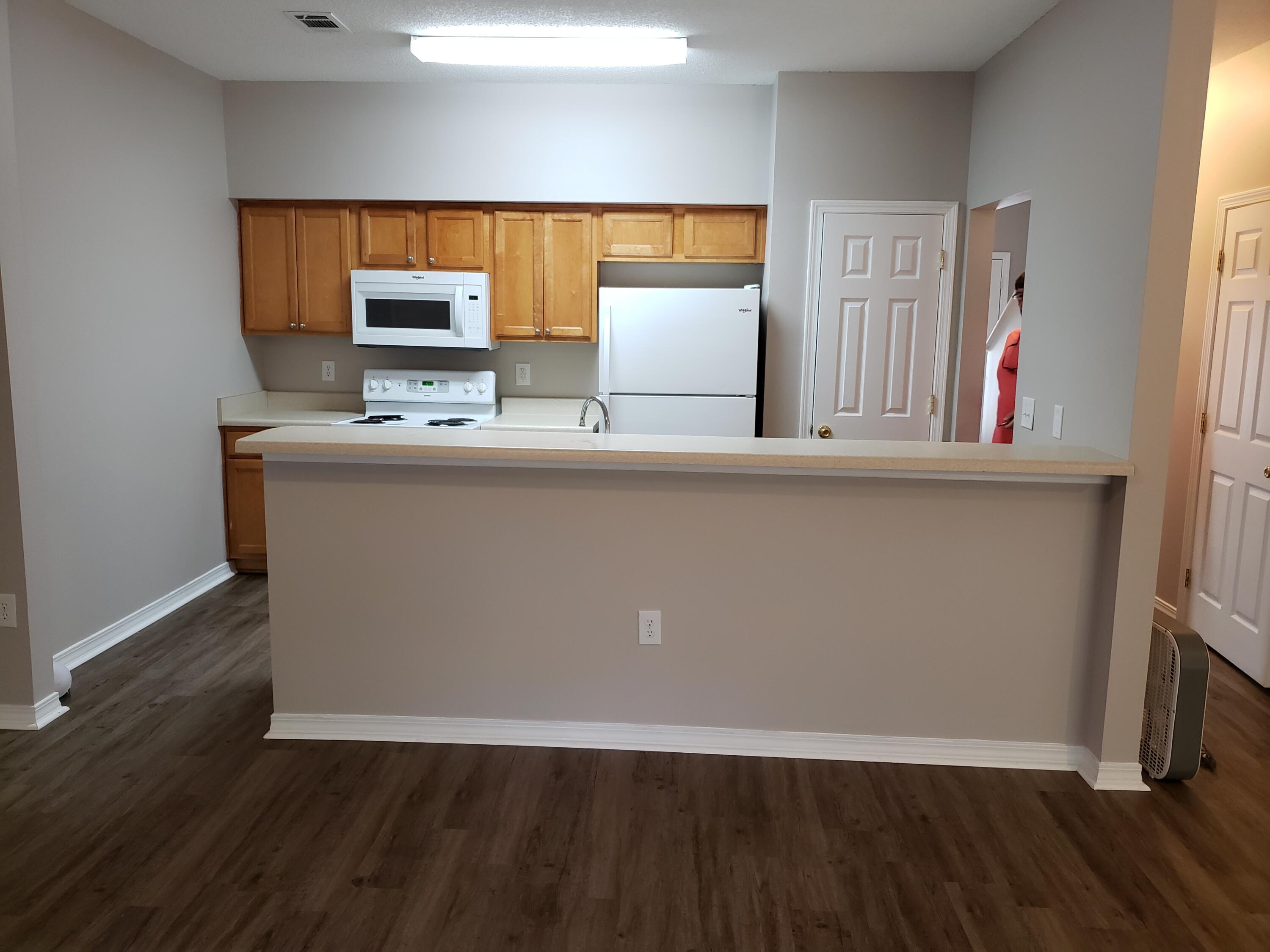 2127 Tom Street Navarre, FL 32566 - Photo 5 of 14 a view of kitchen with wooden floor and window