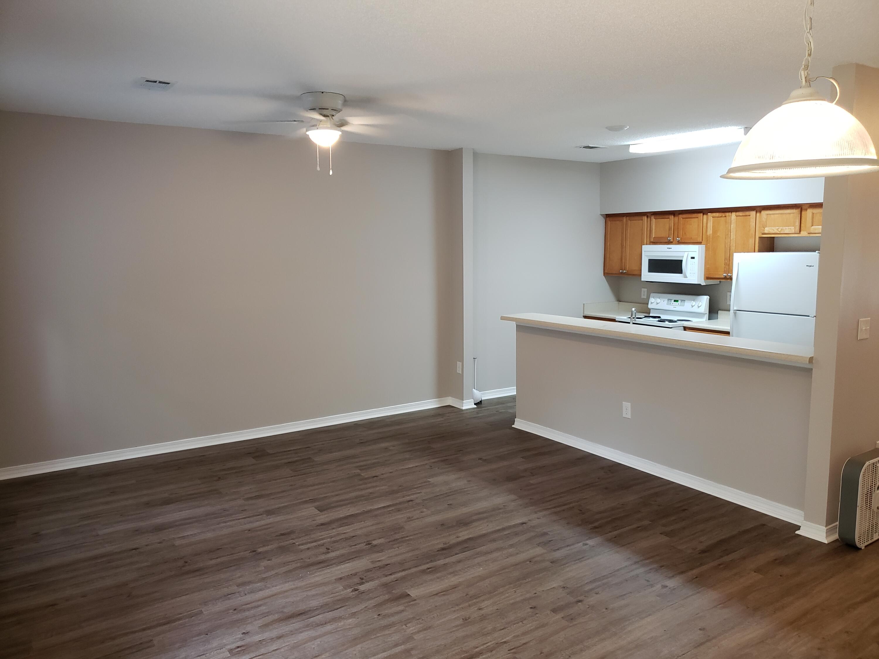 2127 Tom Street Navarre, FL 32566 - Photo 6 of 14 a view of a kitchen with wooden floor and a sink