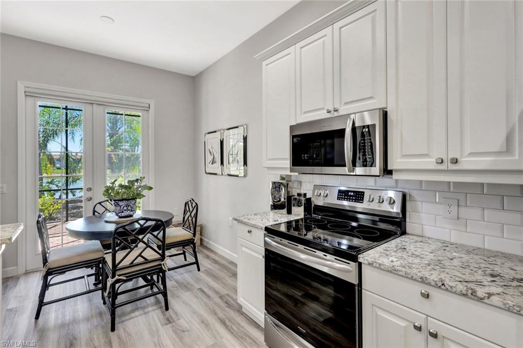 3376 Sandpiper Way Naples, FL 34109 - Photo 18 of 50 Kitchen with Breakfast Area, French Doors to Lanai