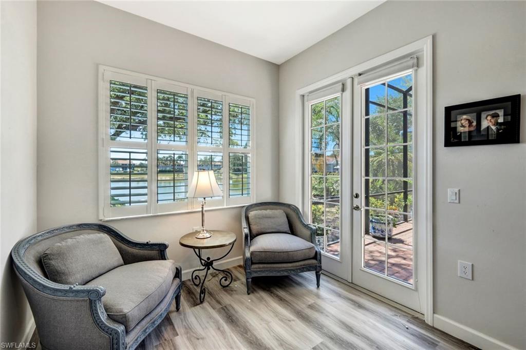 3376 Sandpiper Way Naples, FL 34109 - Photo 22 of 50 Relaxing Sitting Area with French Doors Leading to Sunny Lanai