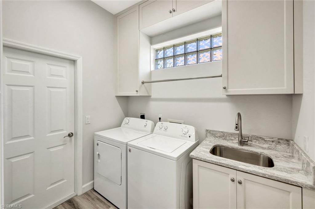 3376 Sandpiper Way Naples, FL 34109 - Photo 31 of 50 Laundry Room with New 2023 Washer, Dryer and New Custom Cabinetry