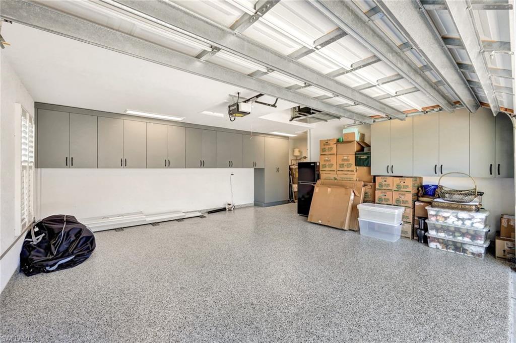 3376 Sandpiper Way Naples, FL 34109 - Photo 32 of 50 Oversized two-car garage, upgraded with custom cabinetry and epoxy flooring.