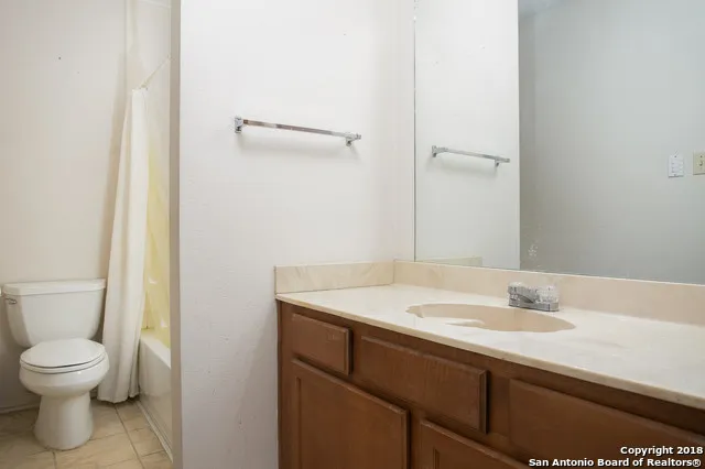 a bathroom with a sink toilet and a mirror