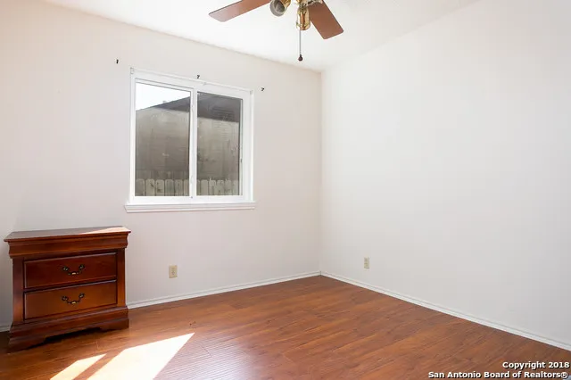 a view of an empty room with a dresser