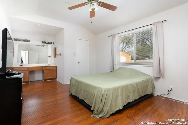 a spacious bedroom with a bed and a chandelier