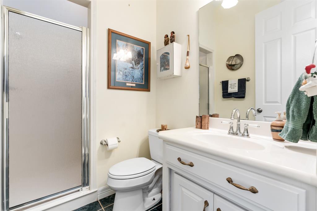 1264 Overlook Drive Whitney, TX 76692 - Photo 14 of 39 a bathroom with a toilet sink and mirror