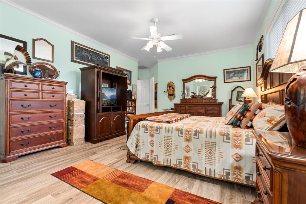 1264 Overlook Drive Whitney, TX 76692 - Photo 17 of 39 a bedroom with a bed a dresser and painting on the wall