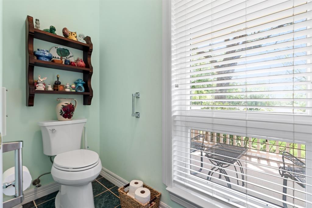 1264 Overlook Drive Whitney, TX 76692 - Photo 20 of 39 a bathroom with a toilet a sink and a window