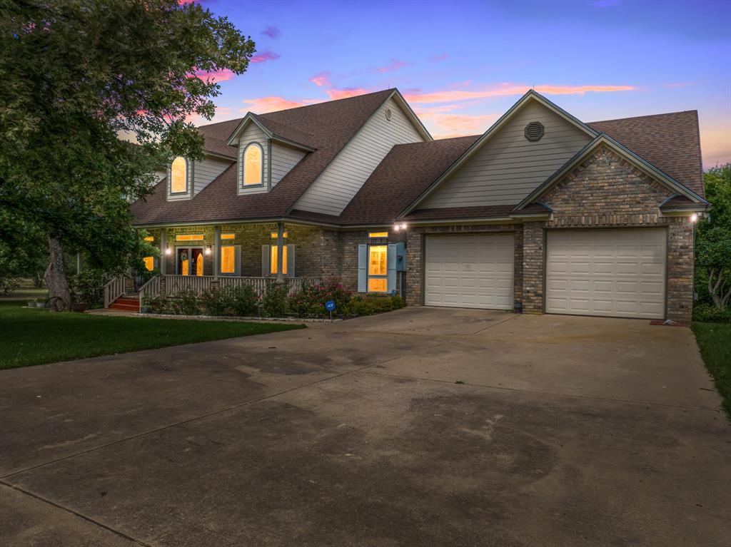 1264 Overlook Drive Whitney, TX 76692 - Photo 2 of 39 a front view of a house with a yard and garage