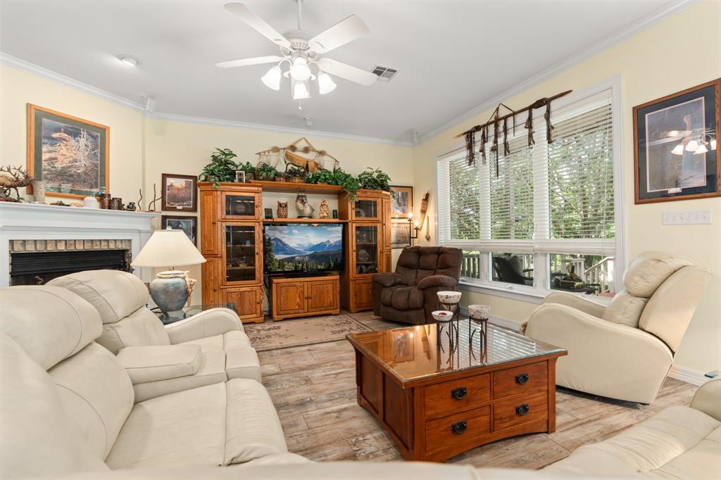 1264 Overlook Drive Whitney, TX 76692 - Photo 24 of 39 a living room with furniture a flat screen tv and a large window