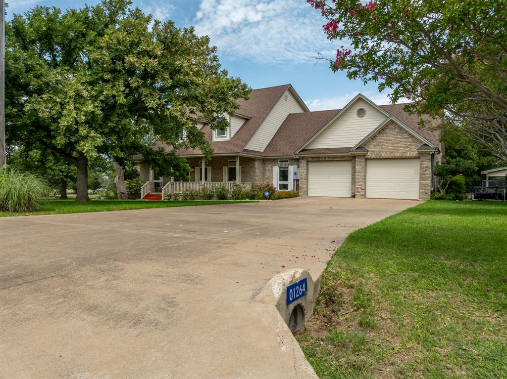 1264 Overlook Drive Whitney, TX 76692 - Photo 3 of 39 a front view of a house with a garden