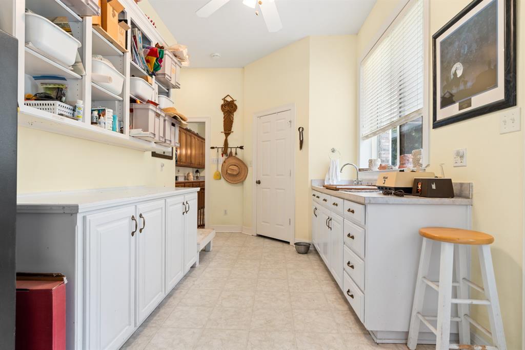 1264 Overlook Drive Whitney, TX 76692 - Photo 31 of 39 a kitchen with cabinets a sink and white appliances