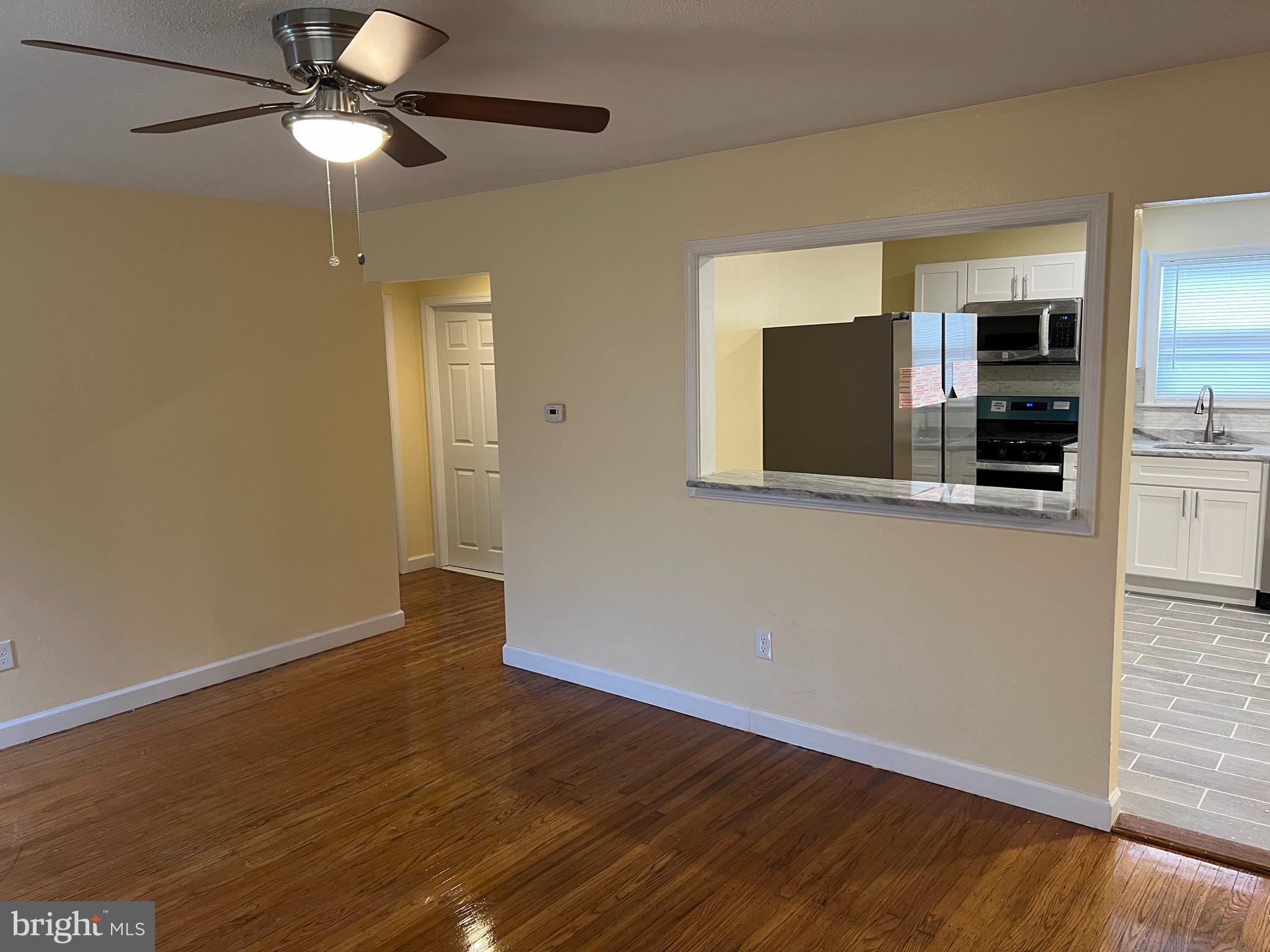 229 Chews Landing Road Lindenwold, NJ 08021 - Photo 11 of 11 a view of a kitchen with wooden floor a ceiling fan and a kitchen