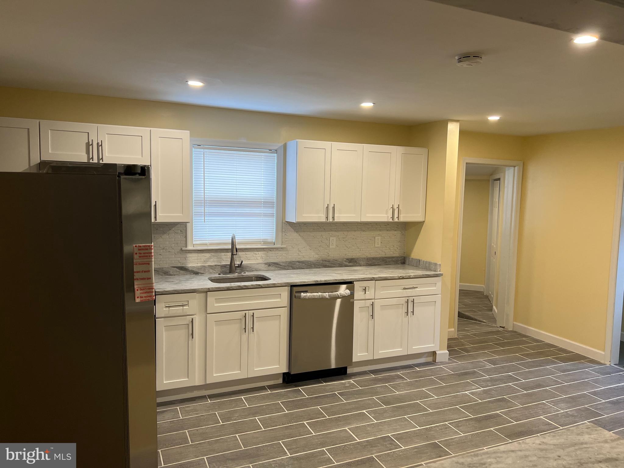 229 Chews Landing Road Lindenwold, NJ 08021 - Photo 4 of 11 a kitchen with stainless steel appliances granite countertop a stove a sink and a refrigerator