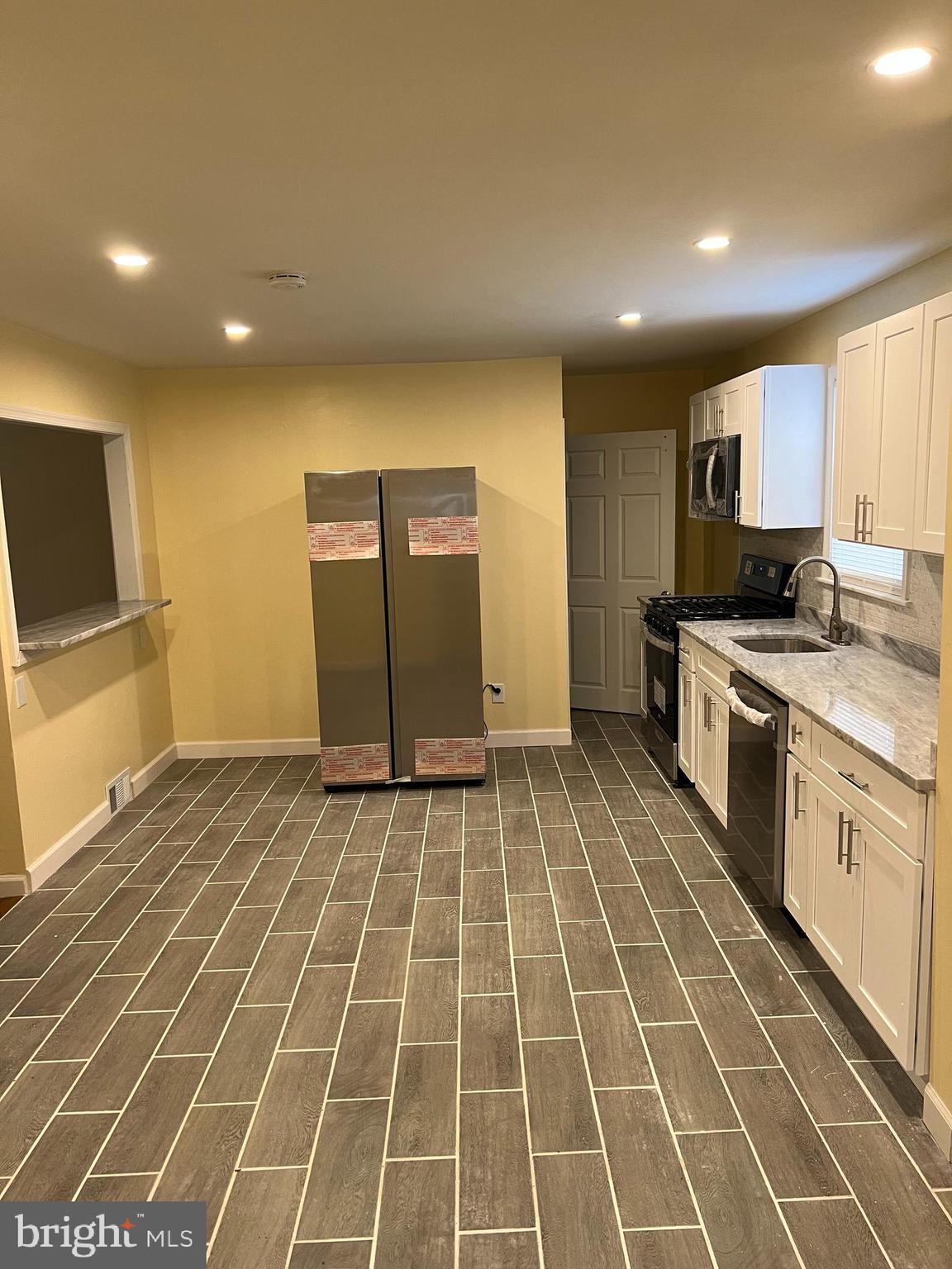 229 Chews Landing Road Lindenwold, NJ 08021 - Photo 5 of 11 a view of a kitchen with a sink and a stove top oven