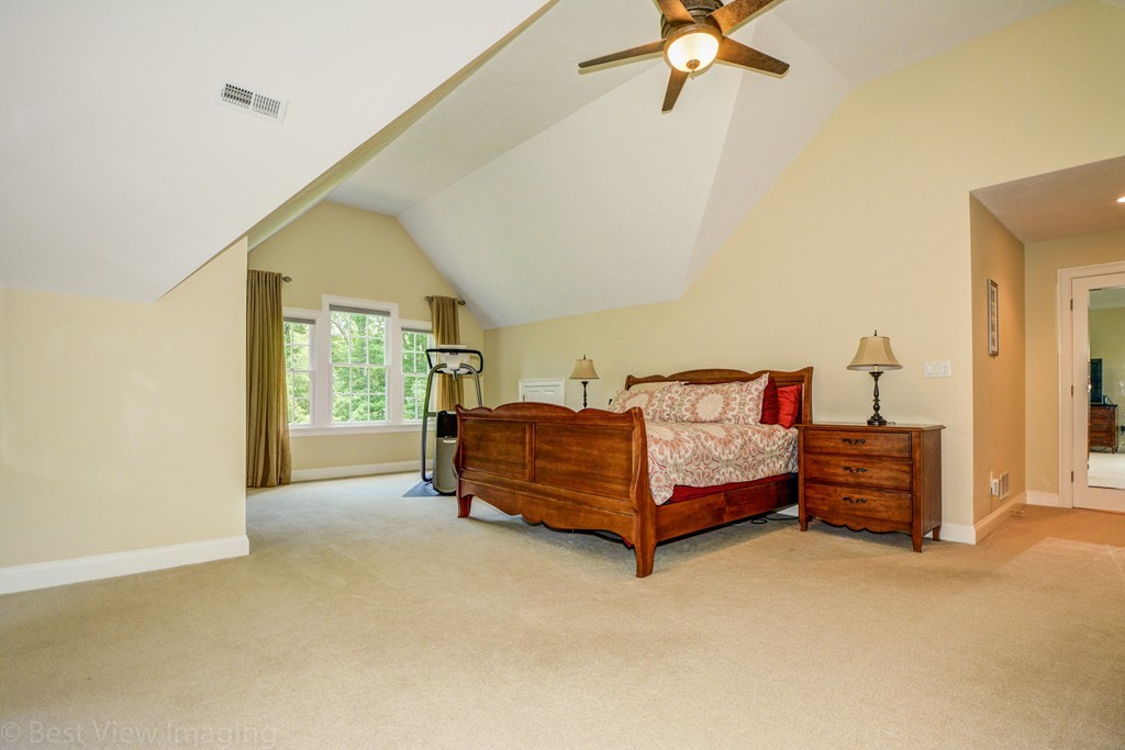 29 Prospect Street Upton, MA 01568 - Photo 21 of 30 a bedroom with a bed and a chandelier