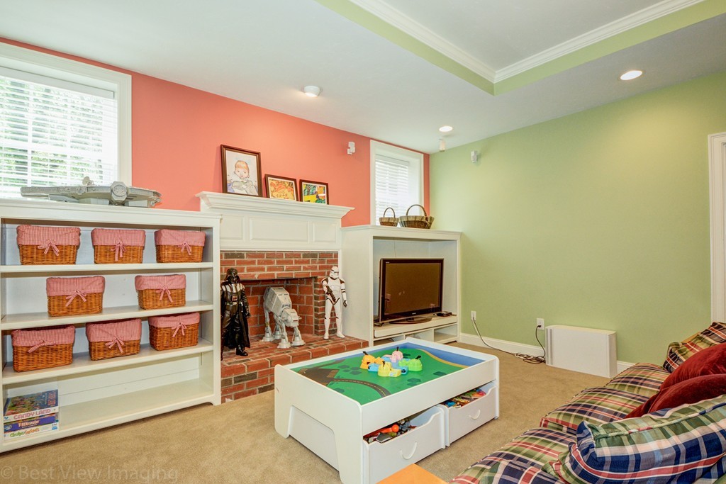 29 Prospect Street Upton, MA 01568 - Photo 29 of 30 a living room with furniture a fireplace and a flat screen tv