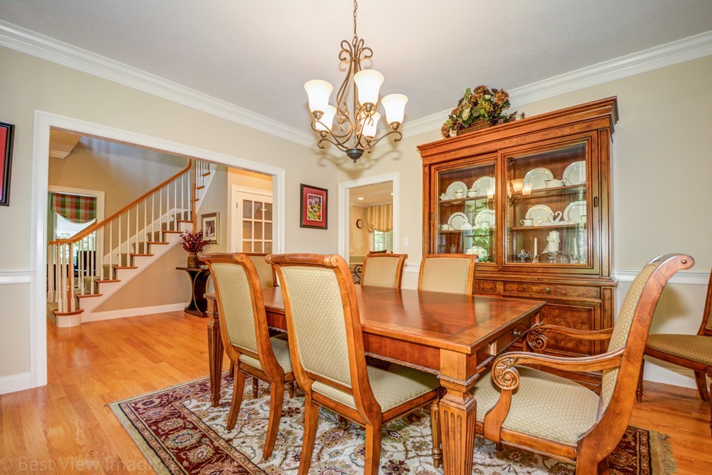 29 Prospect Street Upton, MA 01568 - Photo 8 of 30 a view of a dining room with furniture a chandelier and wooden floor