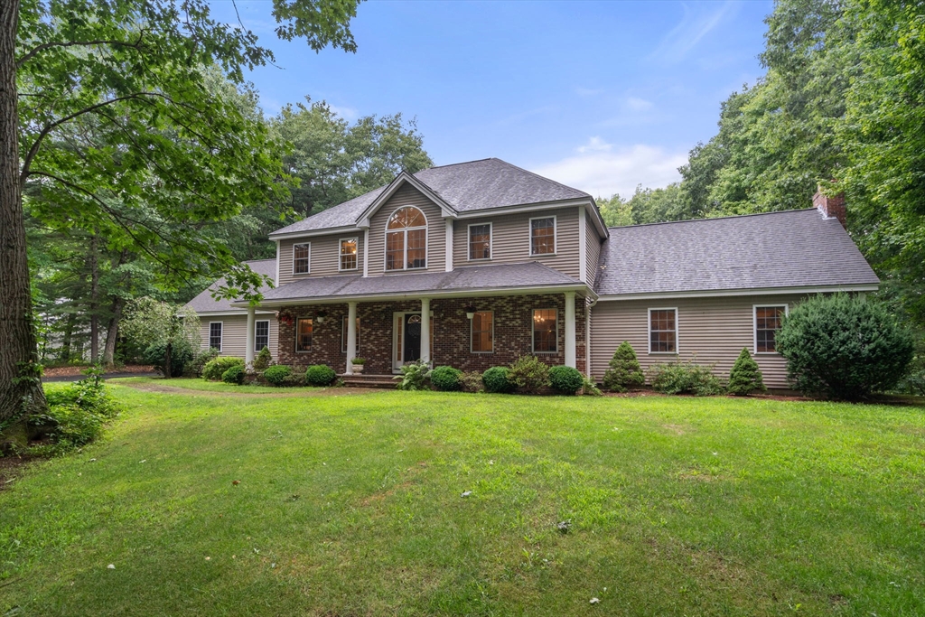 60 Easter Brook Road Lunenburg, MA 01462 - Photo 1 of 37 a front view of a house with a garden
