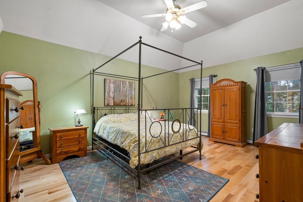 60 Easter Brook Road Lunenburg, MA 01462 - Photo 17 of 37 a bedroom with a bed and a chandelier