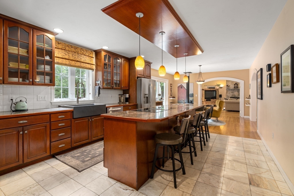 60 Easter Brook Road Lunenburg, MA 01462 - Photo 2 of 37 a dining hall with stainless steel appliances kitchen island granite countertop a table and chairs in it
