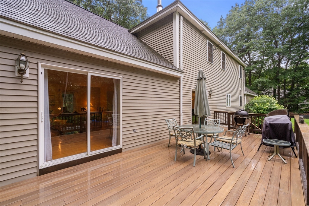60 Easter Brook Road Lunenburg, MA 01462 - Photo 28 of 37 a view of deck with table and chairs and wooden floor