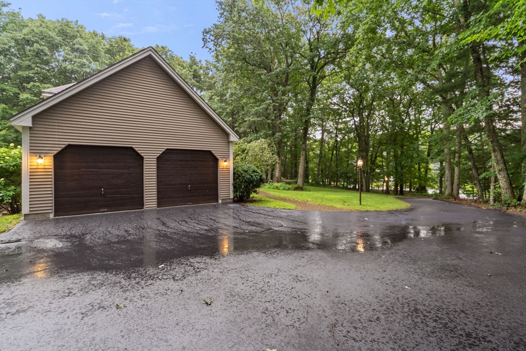 60 Easter Brook Road Lunenburg, MA 01462 - Photo 36 of 37 a view of a big house with a yard and large tree