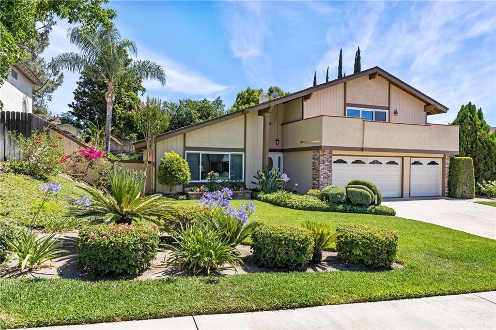 1324 Parkside Drive Riverside, CA 92506 - Photo 1 of 1 a view of a white house with a big yard and potted plants