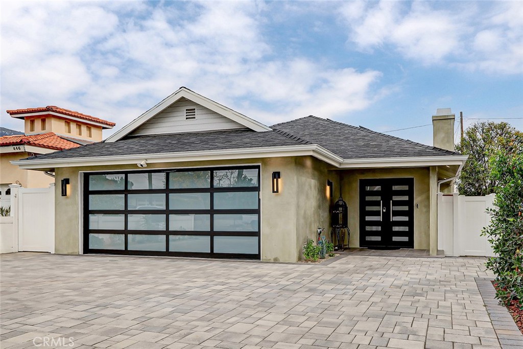 a front view of a house with a garage and yard