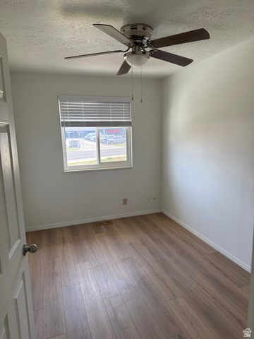 747 Hanover Drive Orem, UT 84058 - Photo 13 of 30 Spare room featuring a textured ceiling, a ceiling fan, and wood finished floors