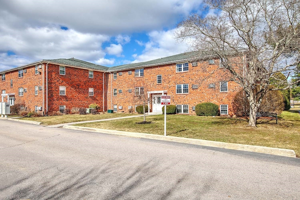 91 Pleasant Street, Unit A6 Medfield, MA 02052 - Photo 1 of 29 a view of a house with a swimming pool and a big yard