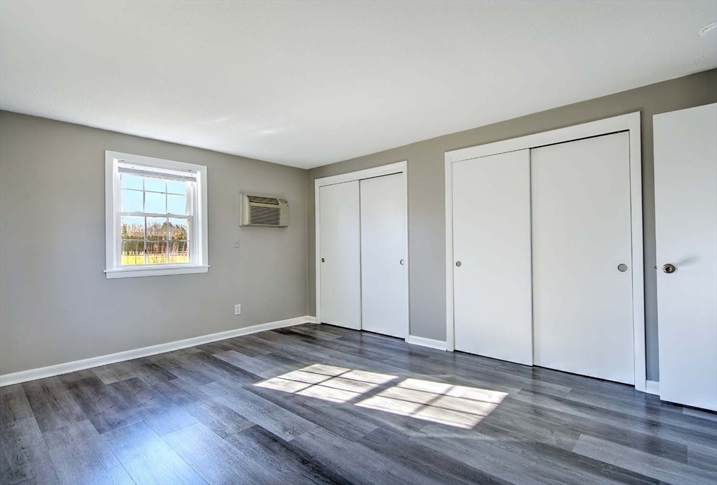 91 Pleasant Street, Unit A6 Medfield, MA 02052 - Photo 18 of 29 a view of a big room with wooden floor and windows