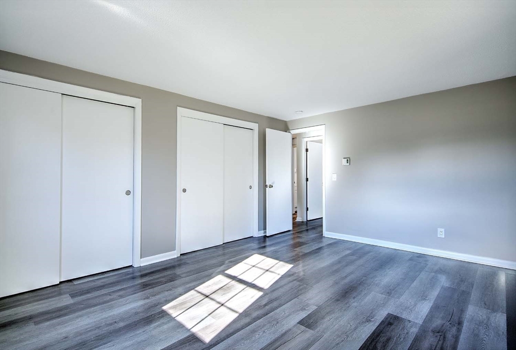 91 Pleasant Street, Unit A6 Medfield, MA 02052 - Photo 19 of 29 a view of wooden floor and windows in a room