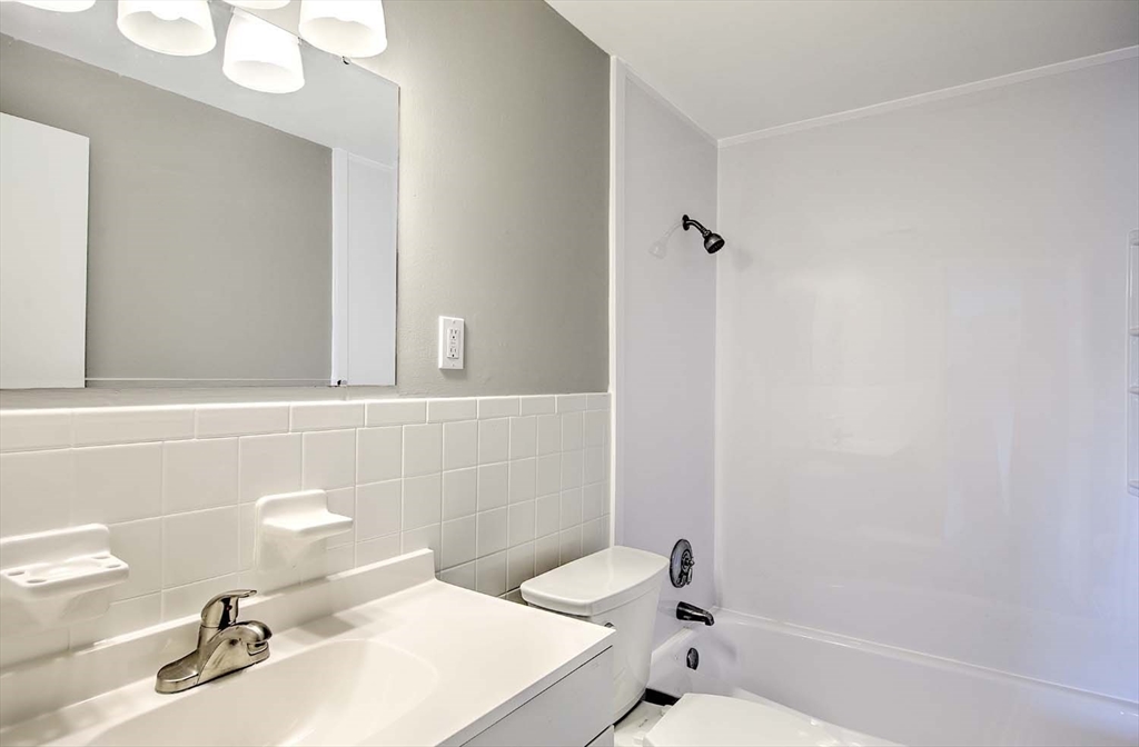 91 Pleasant Street, Unit A6 Medfield, MA 02052 - Photo 21 of 29 a bathroom with a sink a toilet and shower