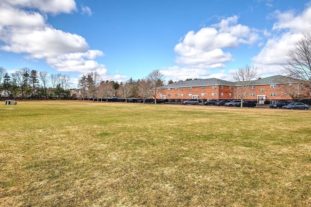 91 Pleasant Street, Unit A6 Medfield, MA 02052 - Photo 27 of 29 a view of building with lake view and mountain in the back